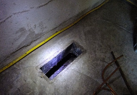 Damage to a concrete floor from a service duct