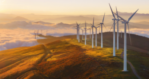 On-shore wind turbines operating in a rural environment under clear skies, showcasing corrosion protection.