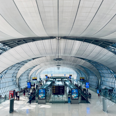 Modern airport concourse with steel frameworks and glass panels, requiring ISO 12944 coating systems for durability.