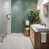 A modern bathroom with sea green and cream walls.