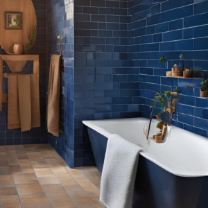 A blue tiled bathroom with wood accents